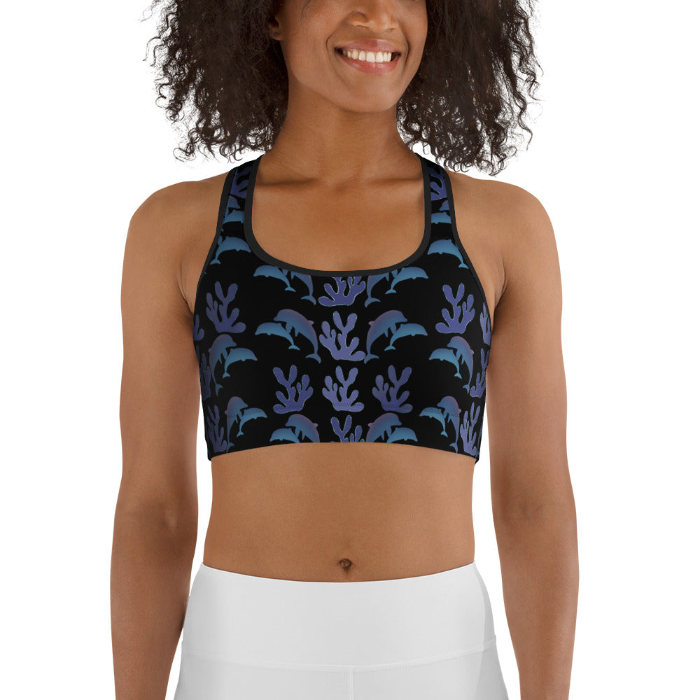 front view of model wearing coral reef dolphins sports bra in black