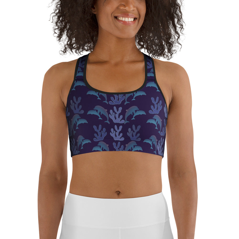  front view of model wearing coral reef dolphins sports bra in purple