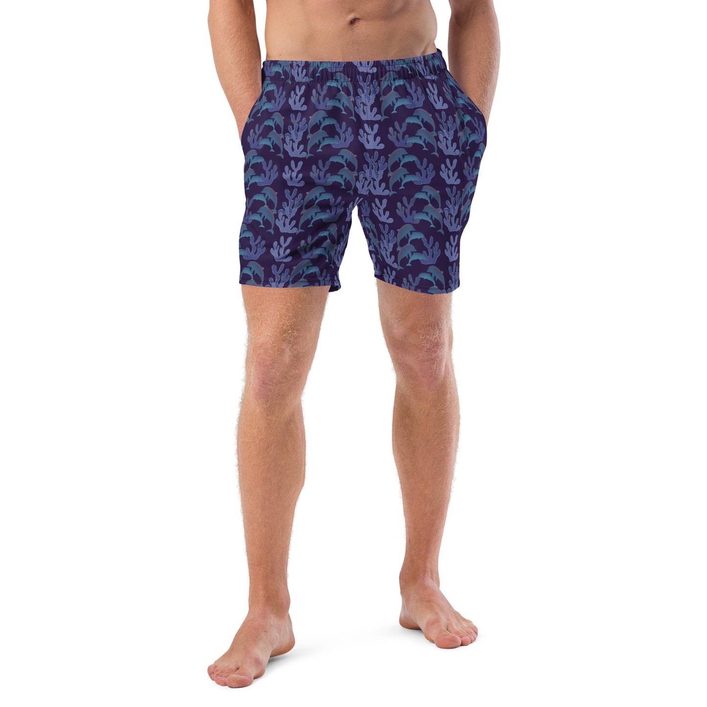 front view of model wearing coral reef dolphins swim trunks in purple