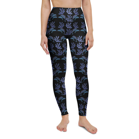 front view of model wearing coral reef dolphins yoga leggings in black