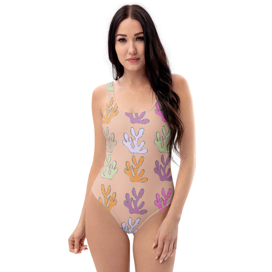 front view of model wearing coral reef swimsuit in peach