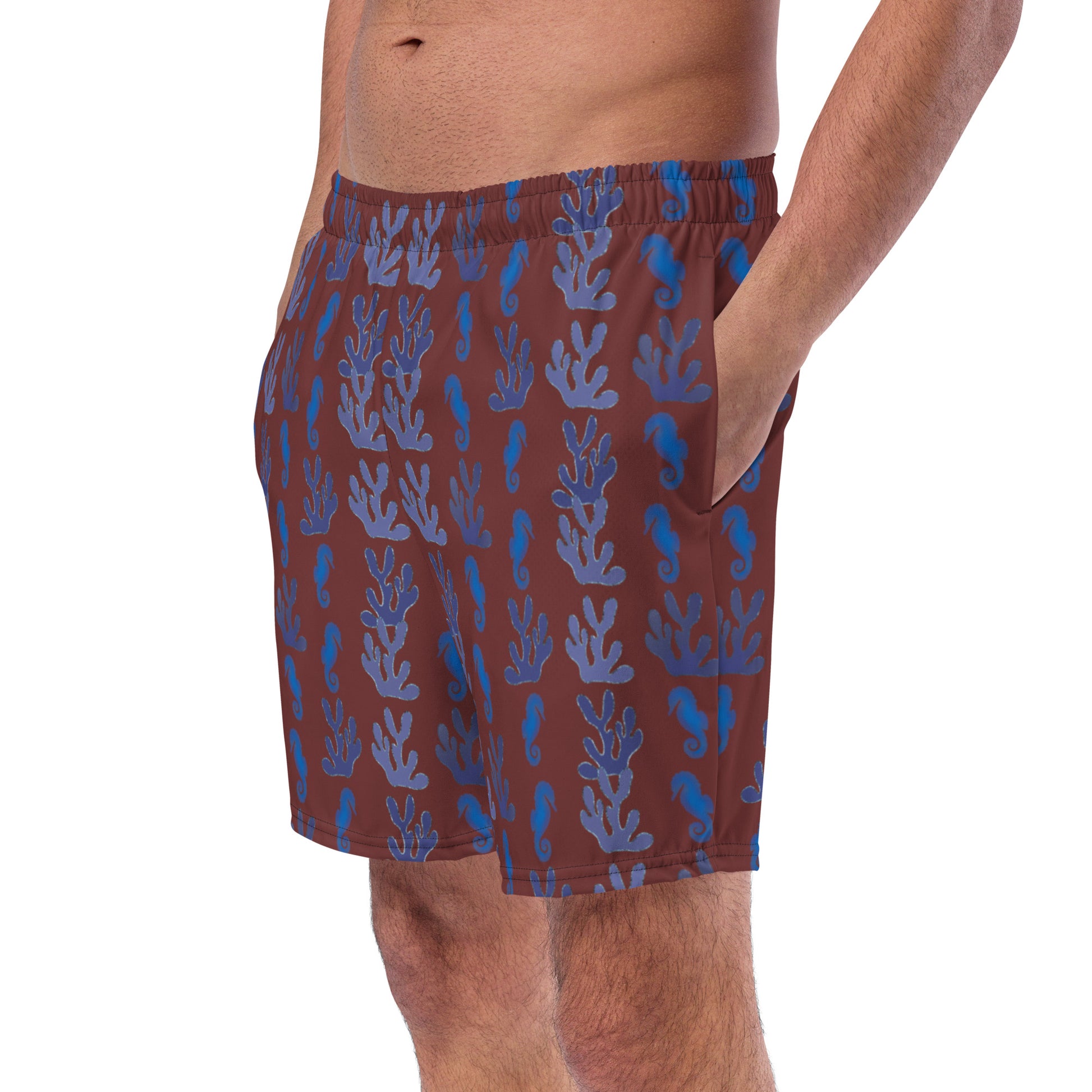 left front view of model wearing coral reef seahorse swim trunks in burgundy