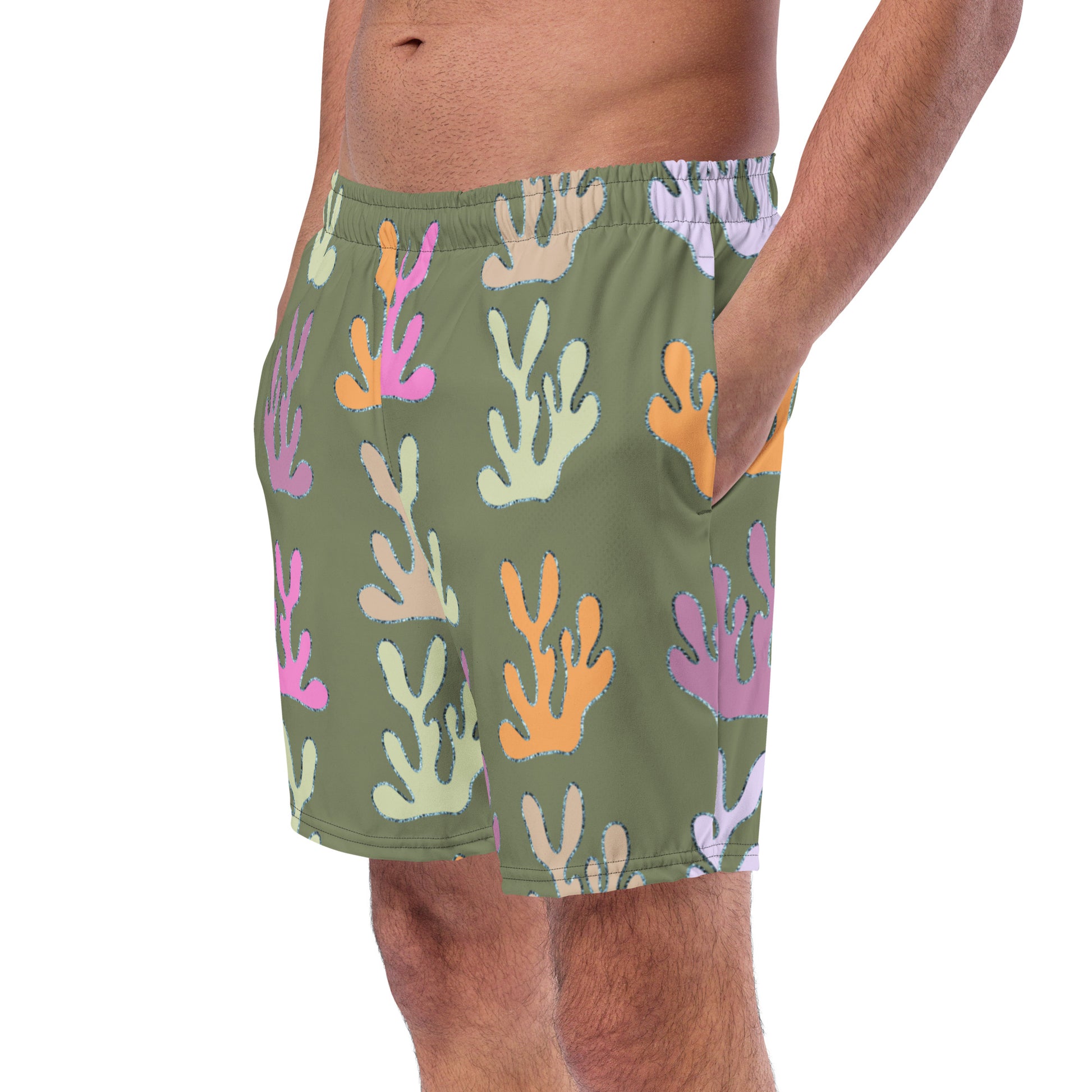 left front view of model wearing coral reef swim trunks in green