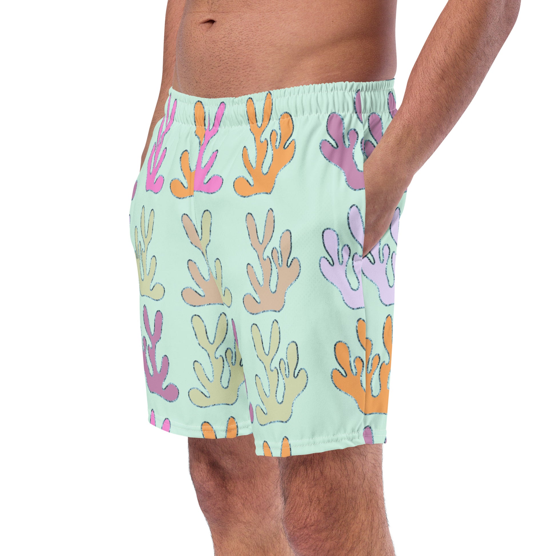 front view of model wearing coral reef swim trunks in lime