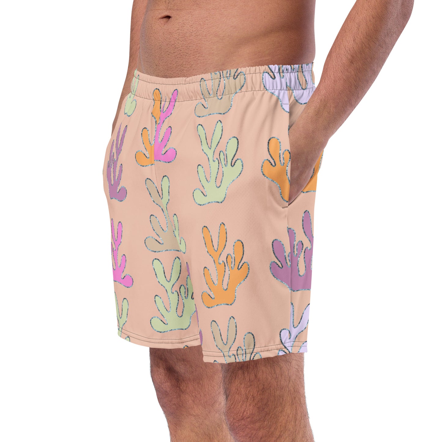 front view of model wearing coral reef swim trunks in peach