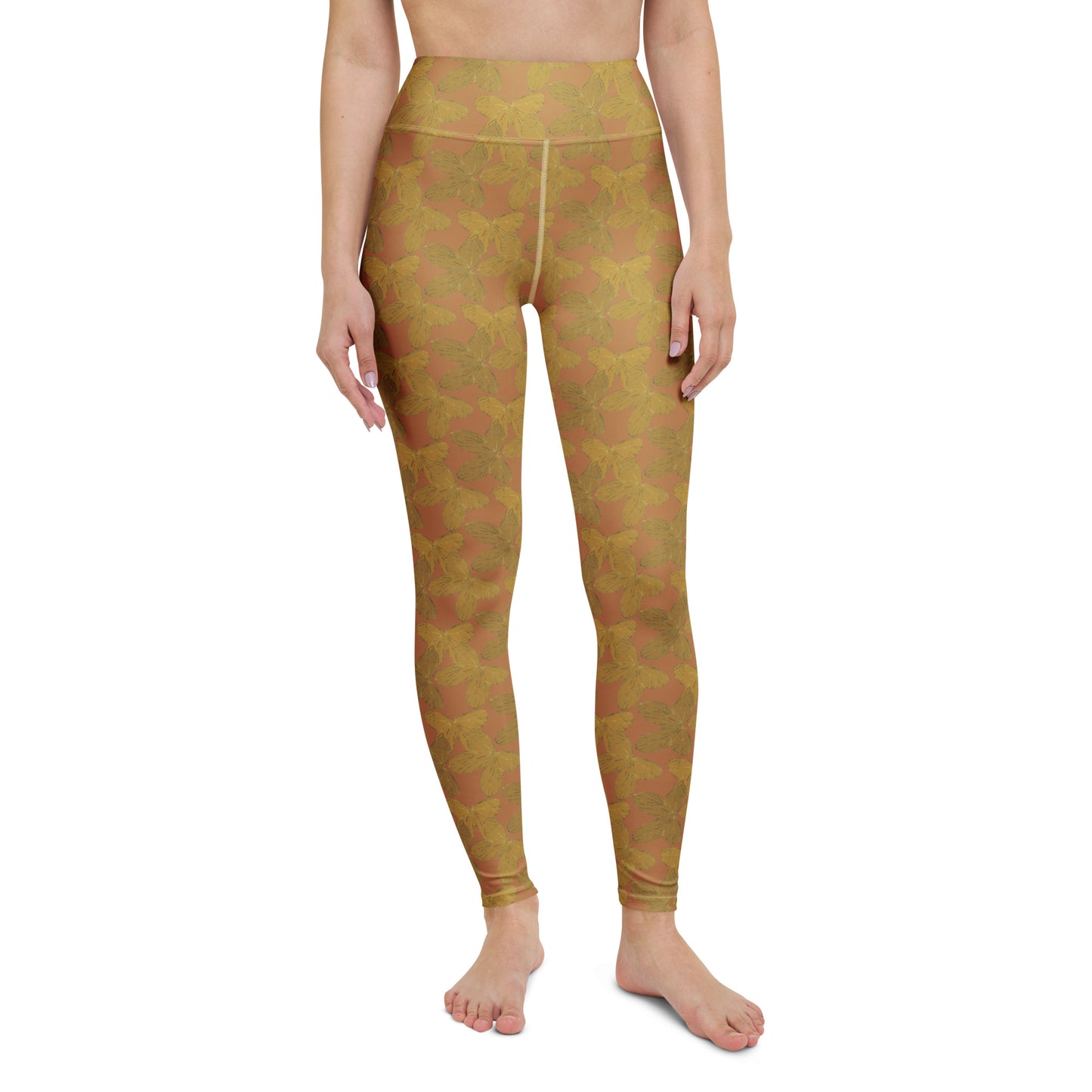  front view of model wearing gold butterfly yoga leggings