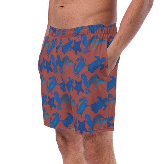 left front view of model wearing seascape swim trunks in terracotta